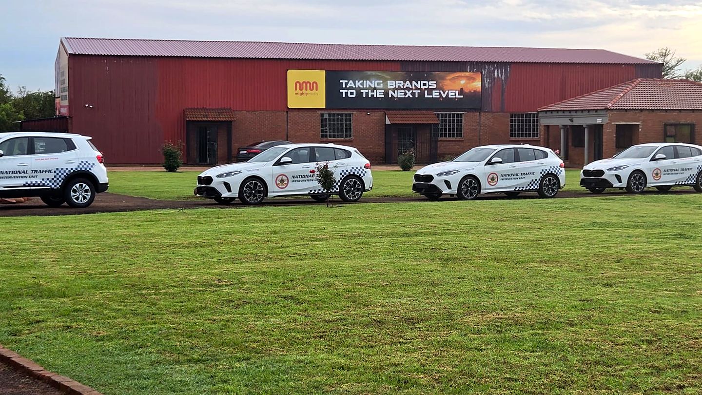 National Traffic Intervention Unit fleet cars lined up in front of the Mighty Media building